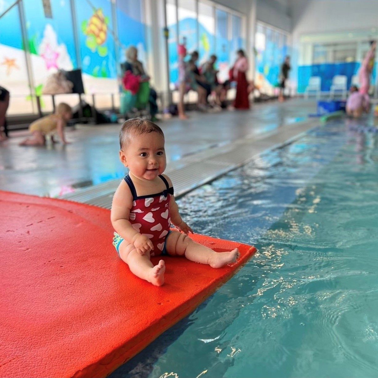 Baby on floating mat in swimming pool